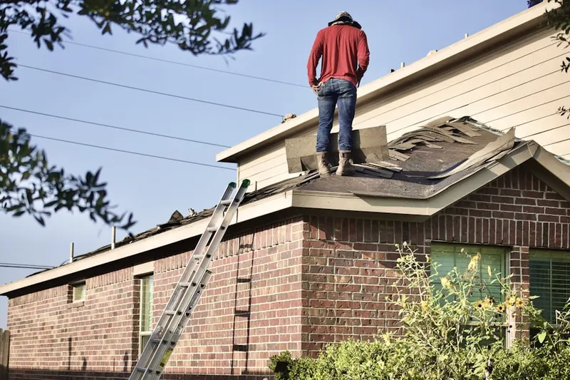 Professional roofer working on a residential roof in Schoolcraft